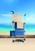 A drying rack with towels is set up on a wooden deck with a beach and ocean in the background. Voir les images du produit