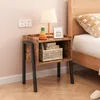 A bedside table next to a bed in a bedroom. Podgląd zdjęcia produktu
