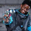 A young boy is smiling and holding up a toy action figure. Náhľad obrázku produktu