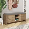 A bench with storage in an entryway, with a plant and coat rack. Produktbild-Vorschau