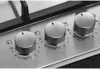 A close-up view of three control knobs on a stainless steel gas hob. Anteprima dell’immagine prodotto