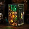 A miniature 3D model of a magical house interior, illuminated by green LED lights, displayed on a wooden surface. Voir les images du produit