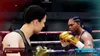 Two female boxers facing each other in a boxing ring during a match. Produktbild-Vorschau