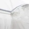 A close-up view of a white pillow with a zipper partially open, revealing white filling. Produktbild-Vorschau