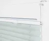 A close-up view of a white window frame with a light gray pleated blind attached. Produktbild-Vorschau