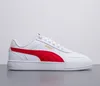 A white Puma sneaker with red accents is shown against a white and light gray background. Produktbild-Vorschau