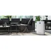 An air purifier is placed in a modern living room next to a sofa. Anteprima dell’immagine prodotto