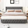 A bed with gray tufted headboard and frame, dressed with white and gray bedding, and pink accent pillows. Voir les images du produit