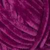 A close-up view of a ball of soft, fuzzy yarn in a deep purple color. Podgląd zdjęcia produktu
