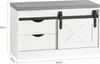 A white shoe bench with a gray upholstered top and two drawers, featuring a sliding barn door. Anteprima dell’immagine prodotto