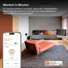 A modern living room with a fireplace, sofa, and TV, with a smartphone displaying a CO detector app in the foreground. Produktbild-Vorschau