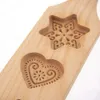 A close-up shot of a wooden cookie mold with carved star and heart shapes. Náhľad obrázku produktu