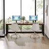A modern home office setup with a large wooden desk and two computer monitors, positioned in front of a large window with a view of trees. Produktbild-Vorschau