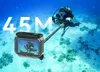 A diver in the ocean holding a camera on a selfie stick, with a waterproof case in the foreground. Produktbild-Vorschau