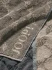 A close-up view of a folded towel with a textured pattern and the brand name "JOOP!" embossed on it. Produktbild-Vorschau