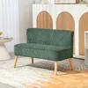 A green upholstered sofa with wooden legs sits on a rug in a room. Anteprima dell’immagine prodotto