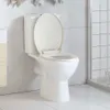 A white toilet with the lid up, set against a tiled wall in a bathroom. Podgląd zdjęcia produktu