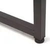 A close-up of the metal leg of a desk with an adjustable foot. Produktbild-Vorschau