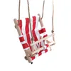 A baby swing seat with red and white stripes, made of wood and fabric, suspended by ropes. Produktbild-Vorschau