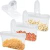 Three clear plastic food storage containers with lids, each filled with different food items: one with brown sugar, one with peanuts, and one with what appears to be garlic cloves. Anteprima dell’immagine prodotto