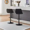 Two black bar stools are shown in a modern interior setting, possibly a kitchen or dining area, with a counter in the background. Produktbild-Vorschau