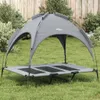 A gray dog bed with a canopy sits on a grassy lawn in front of a wooden fence. Anteprima dell’immagine prodotto