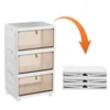 A white three-tier storage cabinet with transparent tan drawers is shown next to a stack of folded storage boxes. Voir les images du produit