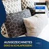 A close-up view of several decorative pillows with geometric patterns, arranged on a bed or sofa. A blue overlay with text and a seal of approval is present. Produktbild-Vorschau
