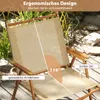 A close-up view of a folding camping chair outdoors, with text overlays highlighting its features. Produktbild-Vorschau
