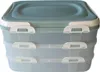 A three-tiered food storage container with white latches and a blue lid. Produktbild-Vorschau