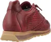 A close-up side view of a red leather sneaker with a tan sole. Voir les images du produit