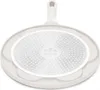 The underside of a white frying pan with a textured cooking surface. Náhľad obrázku produktu