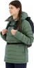 A young woman wearing a green jacket and a backpack. Produktbild-Vorschau