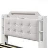 A close-up view of a beige upholstered headboard with white side shelves, part of a bed frame. Produktbild-Vorschau
