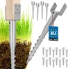 A set of KOTARBAU steel U-bolts ground anchors for fences and pavilions, shown partially installed in the ground with grass. Produktbild-Vorschau