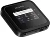 A black NETGEAR Nighthawk M6 Pro mobile hotspot device is shown from a slightly elevated diagonal angle against a white background. The device's screen displays various menu options. Anteprima dell’immagine prodotto