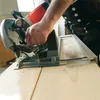 A person is using a MAFELL MKS 130 Ec circular saw to cut wood. Produktbild-Vorschau