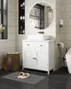 A bathroom vanity with a sink, mirror, and accessories. Voir les images du produit