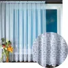 A white lace curtain is shown hanging in a window, with a close-up inset of the lace pattern. Produktbild-Vorschau