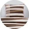 A close-up view of a pillow and bedding with a striped pattern. Produktbild-Vorschau