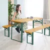 A young girl sits at a wooden picnic table with benches, indoors. Podgląd zdjęcia produktu
