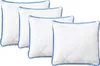 Four white square pillows with blue trim are arranged diagonally. Produktbild-Vorschau