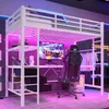 A white loft bed with a desk and gaming setup underneath, illuminated by pink and blue LED lights. Podgląd zdjęcia produktu