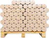 A pallet stacked with many round wood briquettes, wrapped in plastic. Produktbild-Vorschau