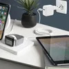 A desk setup with various electronic devices charging. Produktbild-Vorschau