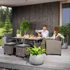 A couple is enjoying a meal on a patio with a polyrattan lounge set. Náhled obrázku produktu