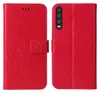 A red flip phone case with a floral and butterfly embossed design is shown open, displaying the inside and the back of the case with the phone camera cutout. Produktbild-Vorschau