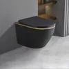 A black wall-mounted toilet with a gold trim is shown against a gray wall and a concrete floor. Produktbild-Vorschau