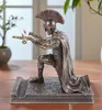 A bronze-colored figurine of a Roman centurion kneeling with a sword, placed on a table. Produktbild-Vorschau