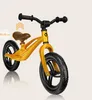 A yellow balance bike is shown against a light beige background. Produktbild-Vorschau